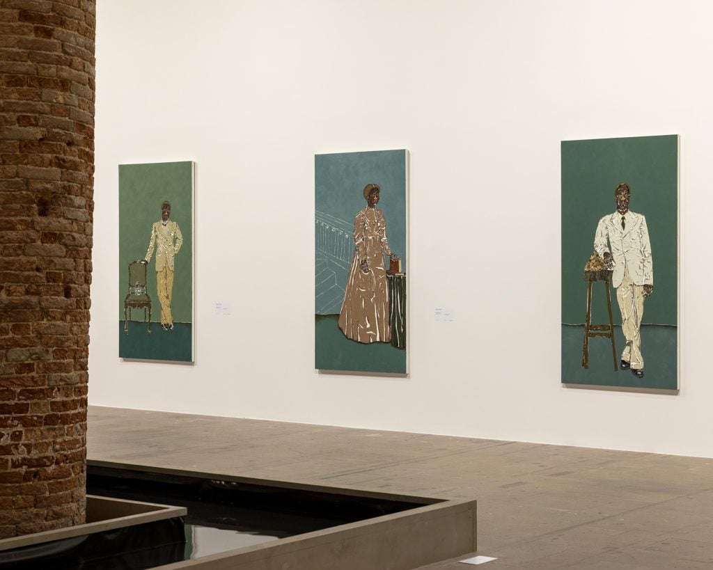 three portraits line a museum wall 