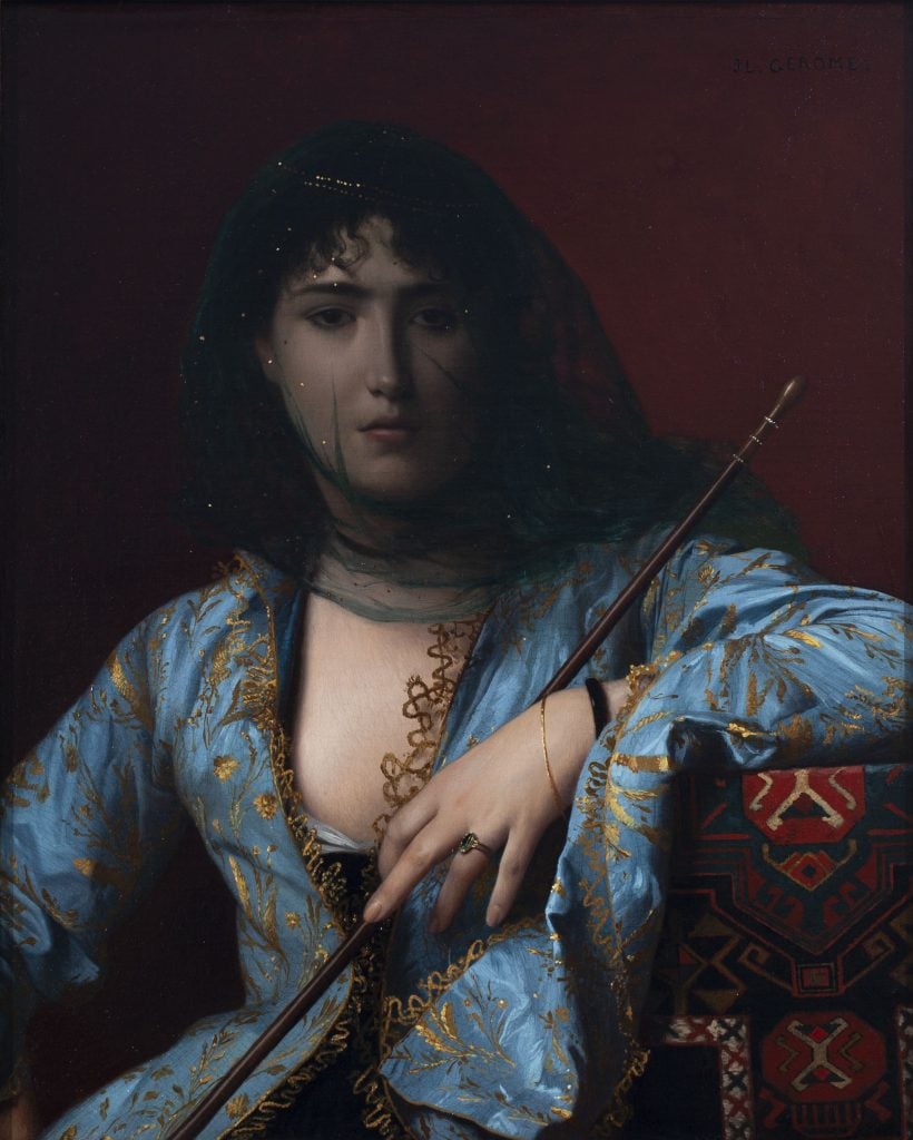 Portrait painting by Jean-Léon Gérôme showing a richly dressed woman in blue wearing a sheer black veil over her face holding a long stick.