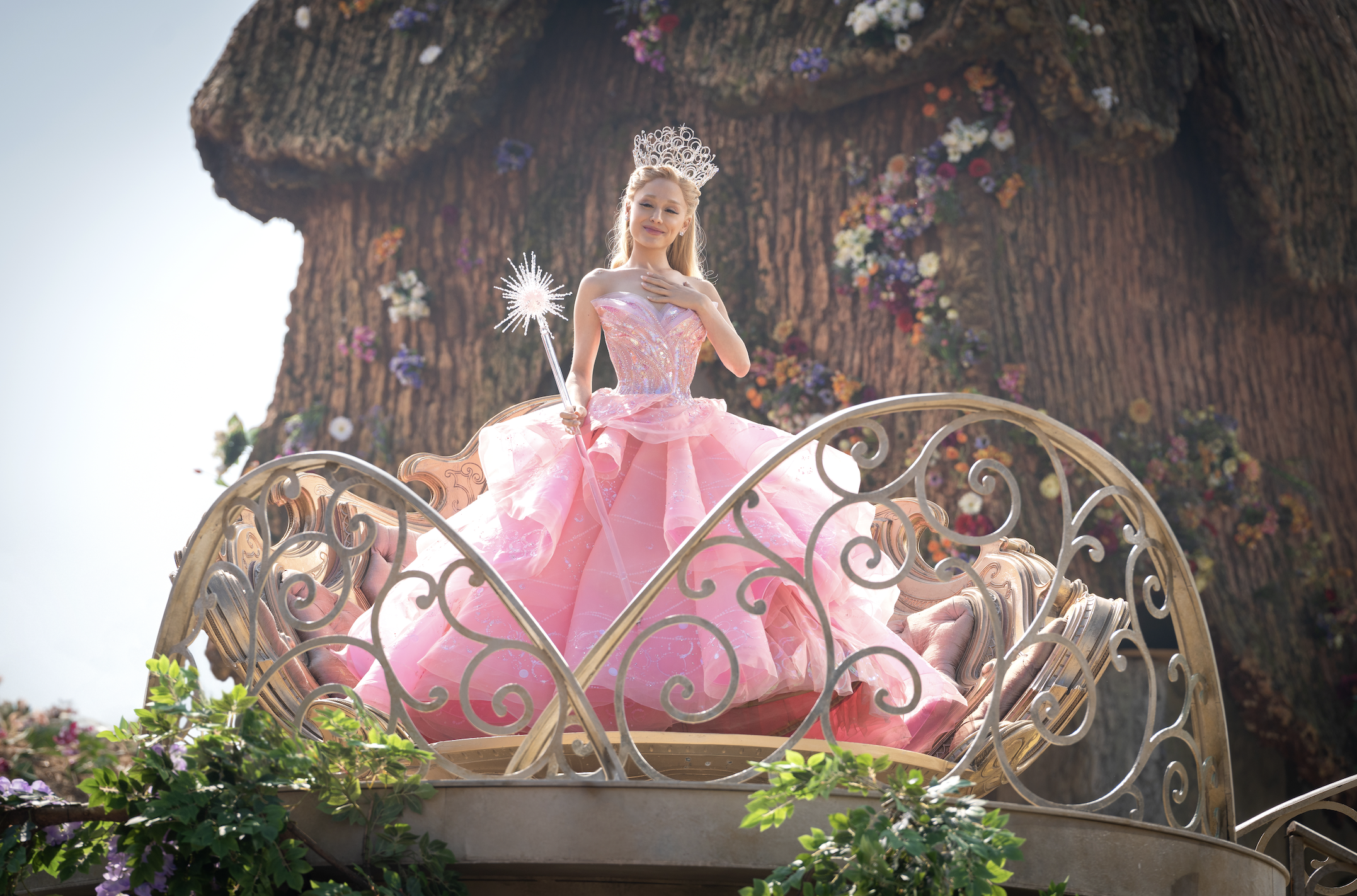 A photograph of Ariana Grande in a huge pink gown while playing Glinda in Wicked.