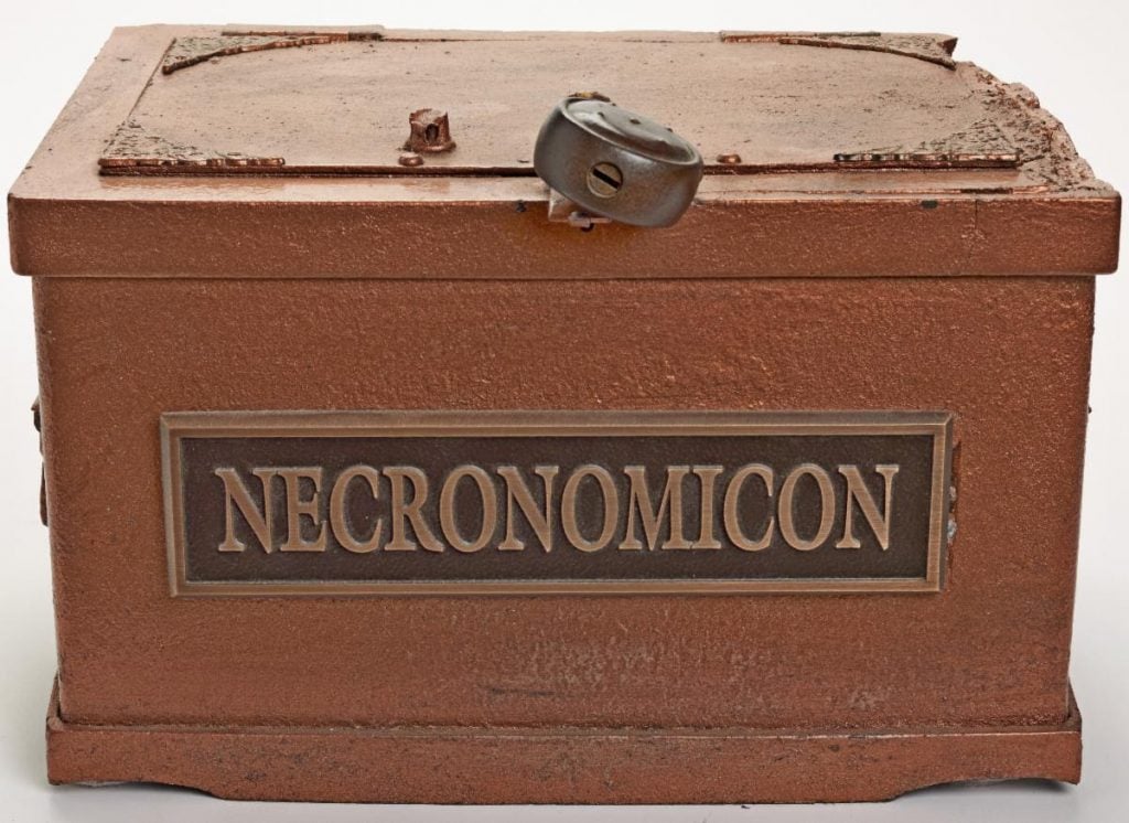 the red brown metal box with the word necronomicon written on it