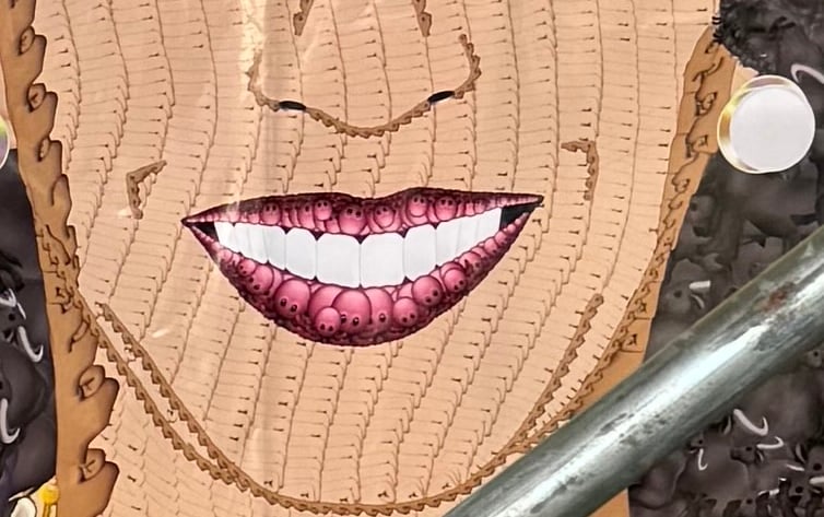 A detail of a poster featuring a woman's face made out of emojis