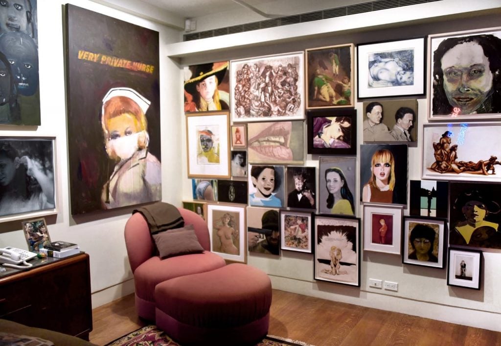 a living room is filled with female figurative paintings 