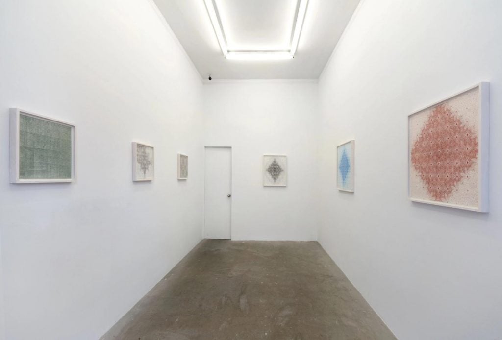 an art gallery with abstract drawings hung on the walls