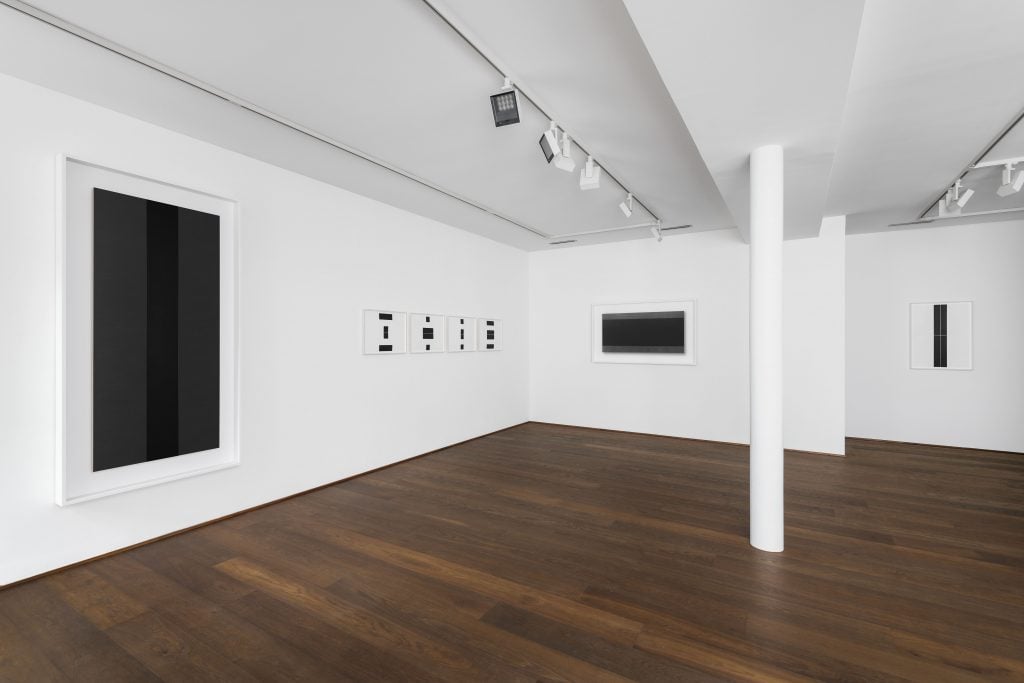 Installation view of "Frank Gerritz: Seraphic Light" with a range of minimalist black geometric paintings installed on the walls.