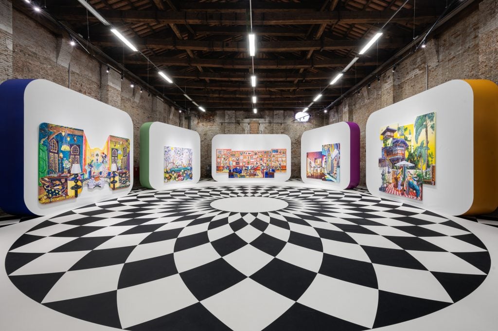 Installation view of solo exhibition of work by Tomokazu Matsuyama in Venice, showing five standalone, rounded corner panel walls around a circular black and white tiled floor under a cavernous, beamed arsenale ceiling.