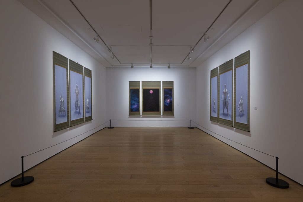 Installation view of "Tenmyouya Hisashi: Game of Thought" showing a long gallery with three works comprised of three illustrated scrolls.