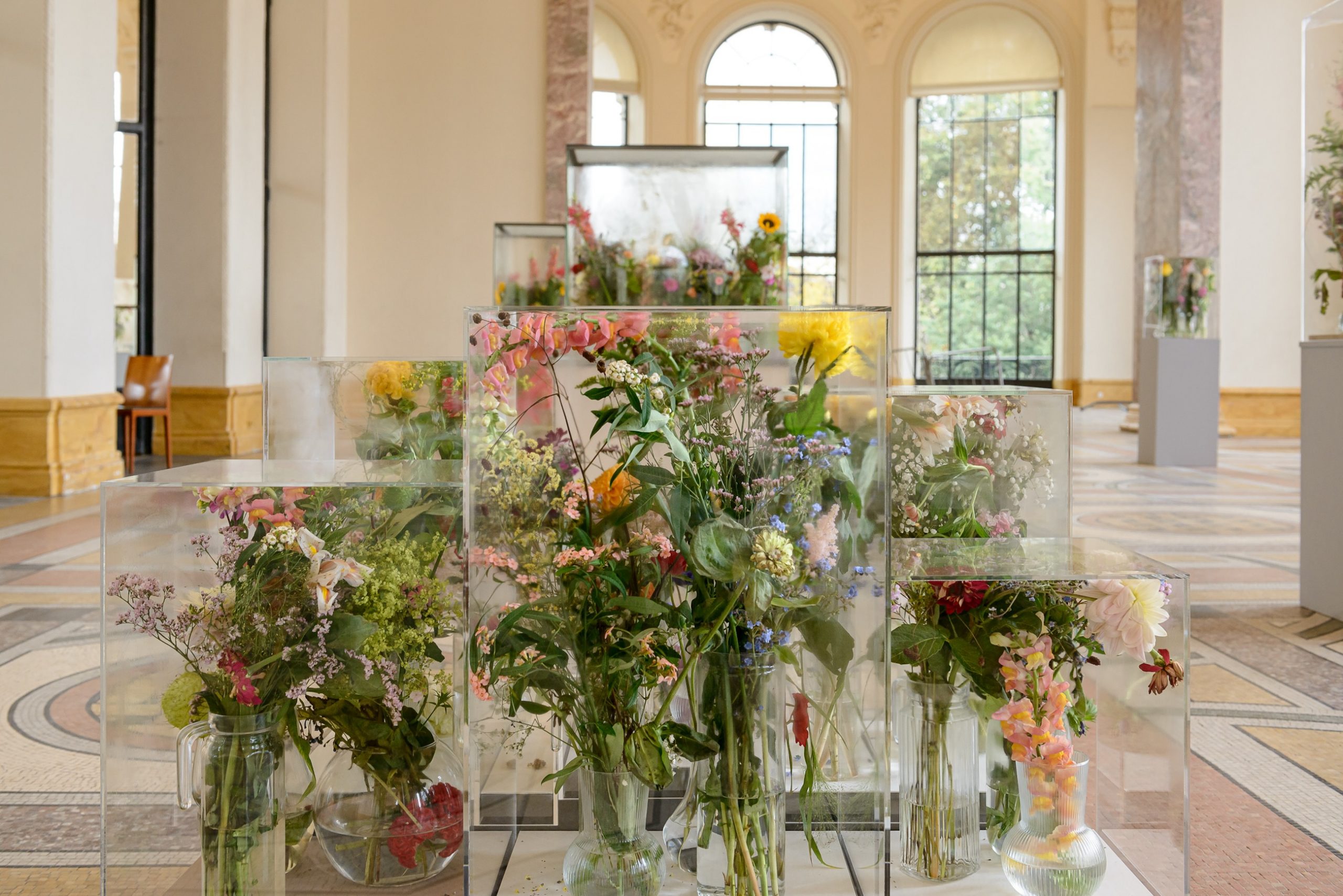 Bouquets of flowers inside plastic vitrines