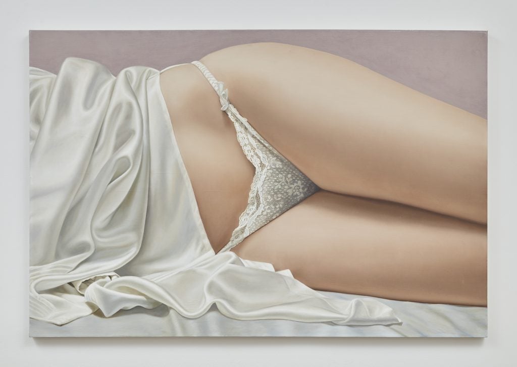 A photograph of a painting by John Kacere featuring the reclining torso of a woman wearing white lacie panties and a white night gown pulled up by her waist.