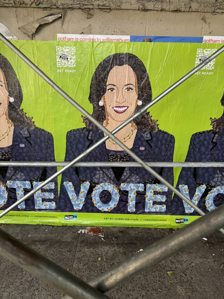 A political poster of a woman's face saying VOTE