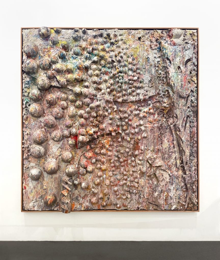 Artnet Auctions Post-War and Contemporary Art sale lot by Larry Poons of a square painting in muddled colors that merge into a grayish hue with objects adhered to the canvas under the pigment giving it a three-dimensional quality.