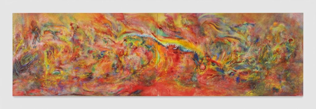 large horizontal abstract painting dominated by reds and yellows