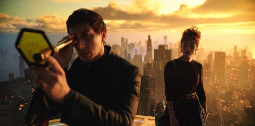 Still from Megalopolis showing a man gazing through a telescope and a woman behind him, a cityspace in the background