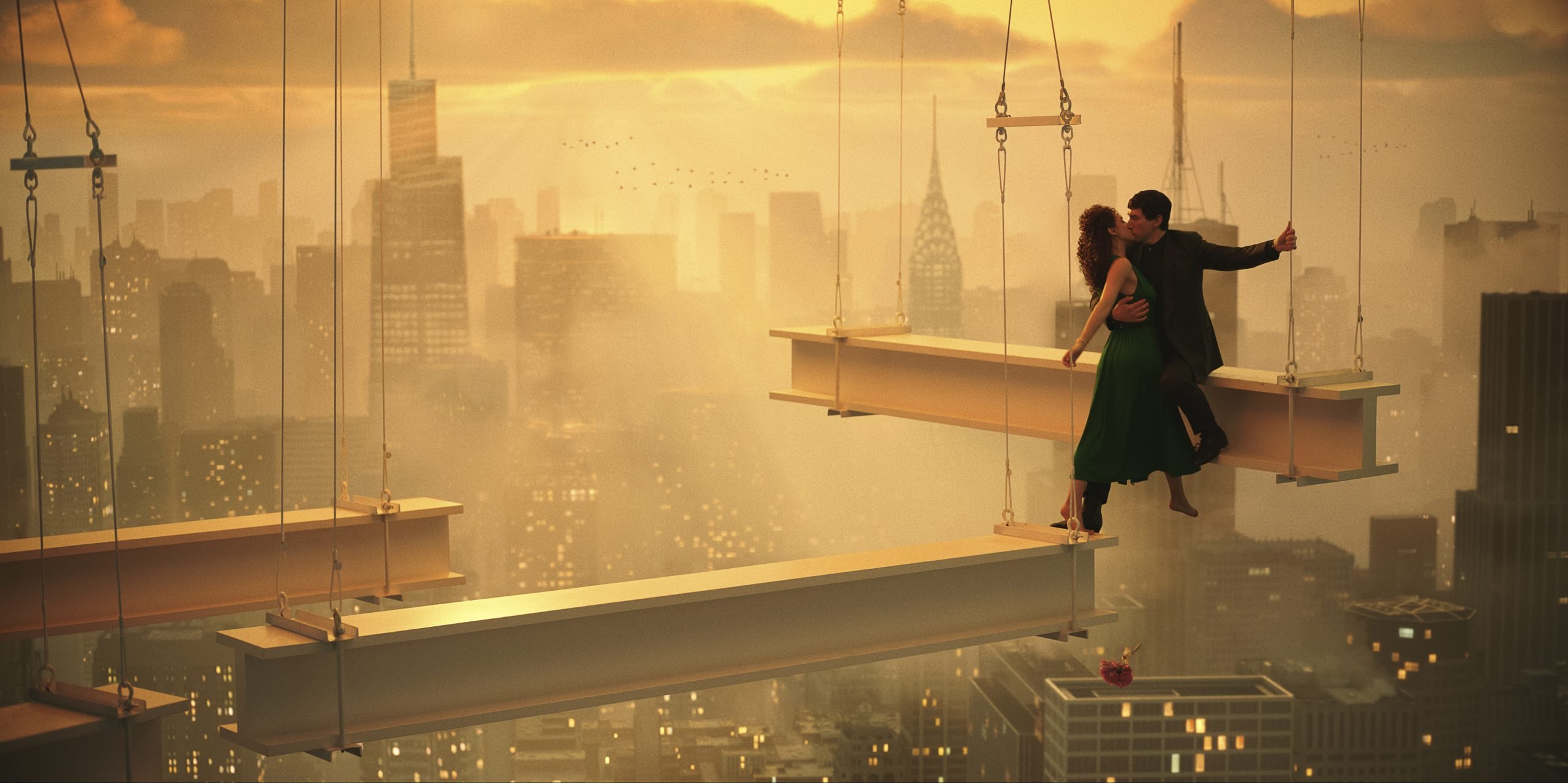 A still from Megalopolis showing a man and woman kissing while dangling above a cityscape