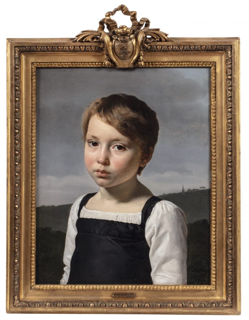 Highlight from FAB Paris fair of a painting by Michel-Martin Drolling in a gold frame of a a young girl wearing a white long-sleeve chemise under a black pinafore in front of a grayish blue sky.