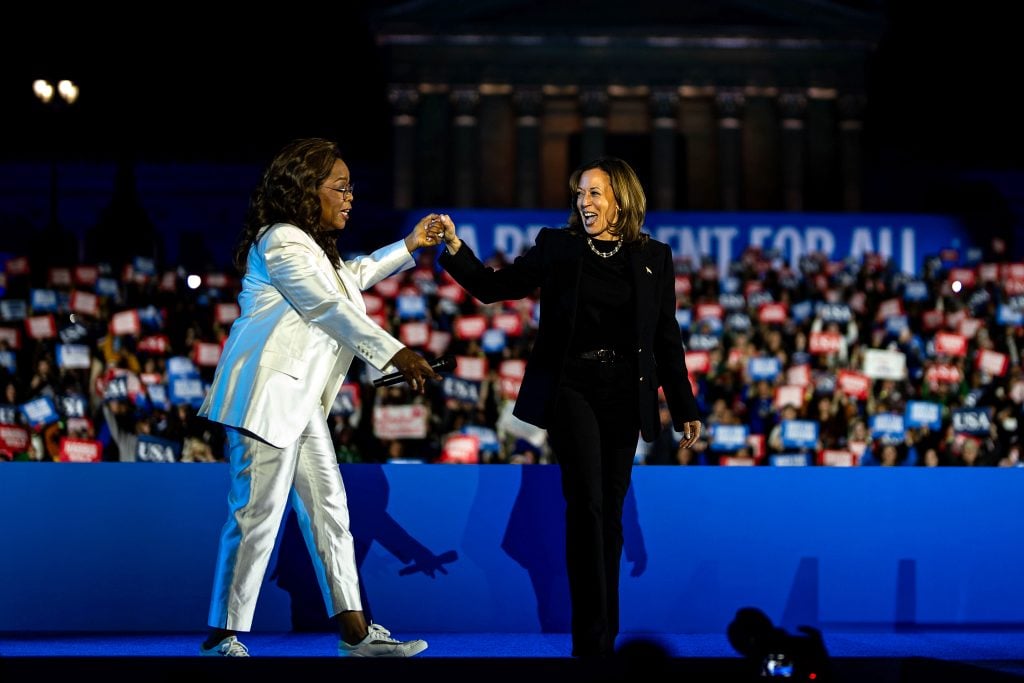 Democratic presidential nominee, U.S. Vice President Kamala Harris greets Oprah Winfrey during the closing rally of her campaign at the base of the iconic "Rocky Steps" at the Philadelphia Museum of Art on November 05, 2024 in Philadelphia, Pennsylvania.