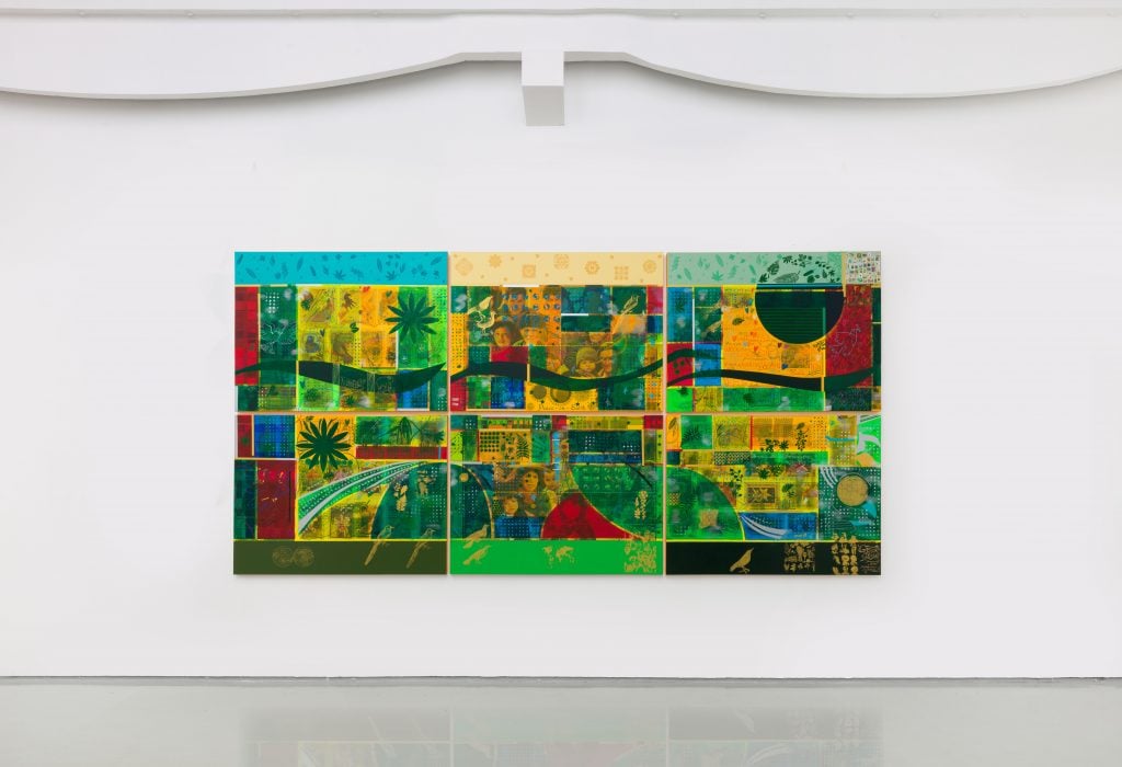 Large colorful mural featuring abstract patterns, nature-inspired designs, and vibrant green and yellow tones, displayed in a modern gallery with a minimalistic white interior.