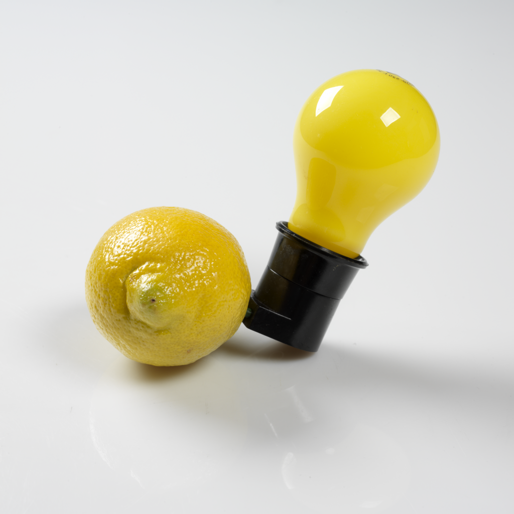 A light bulb plugged into a lemon