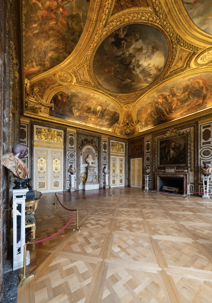 A landscape photograph capturing the room, and ceiling, of Le Salon de Diane at Versailles, which is starting a restoration.