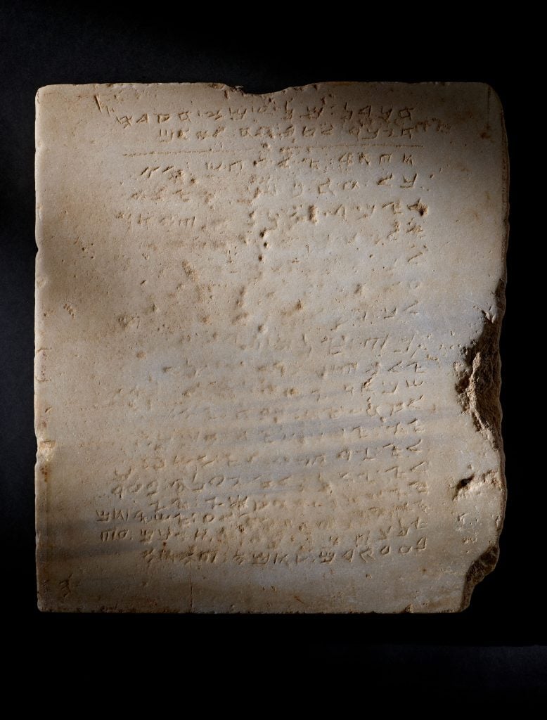 An ancient stone tablet carved with the Ten Commandments