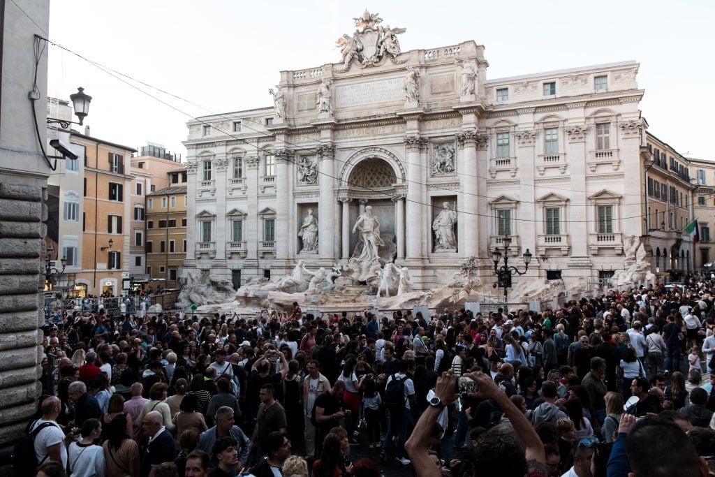 The Trevi Fountain, surrounded by a net due to the start of maintenance work, has a rectangular basin installed to prevent tourists from throwing coins on November 1, 2024, in Rome, Italy. 