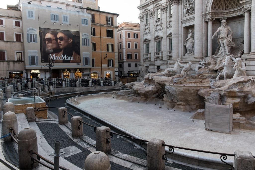 The Trevi Fountain, surrounded by a net due to the start of maintenance work, has a rectangular basin installed to prevent tourists from throwing coins on November 1, 2024, in Rome, Italy.