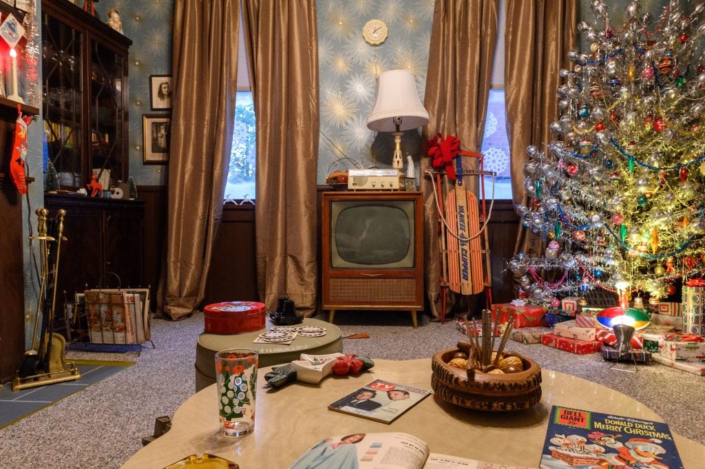 a interior with a a mid century home with a christmas tree and presents