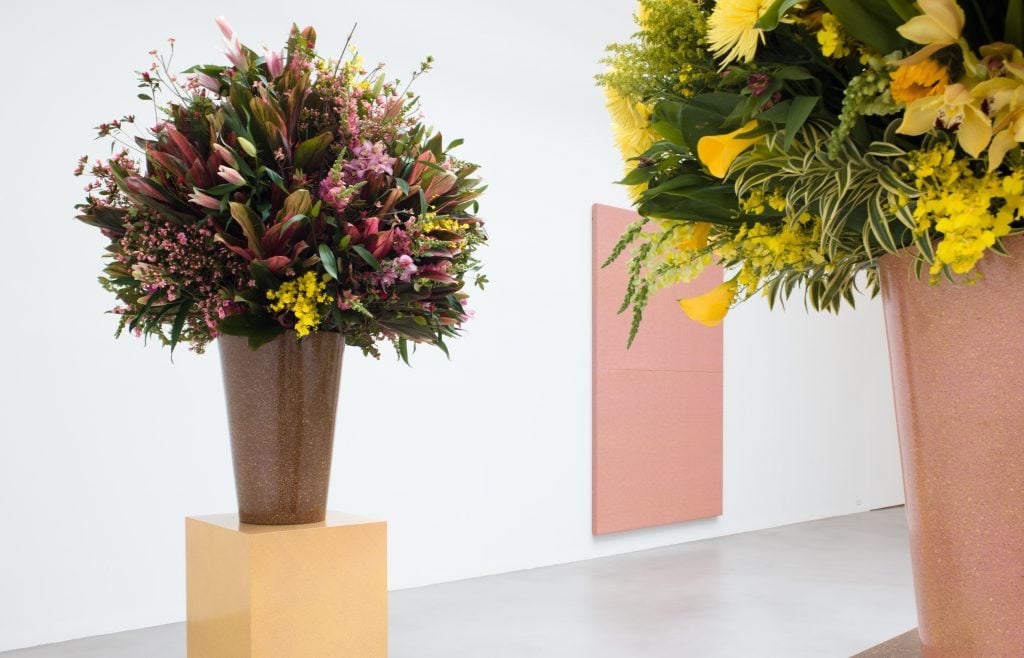 Two large bouquets of flowers in an art gallery