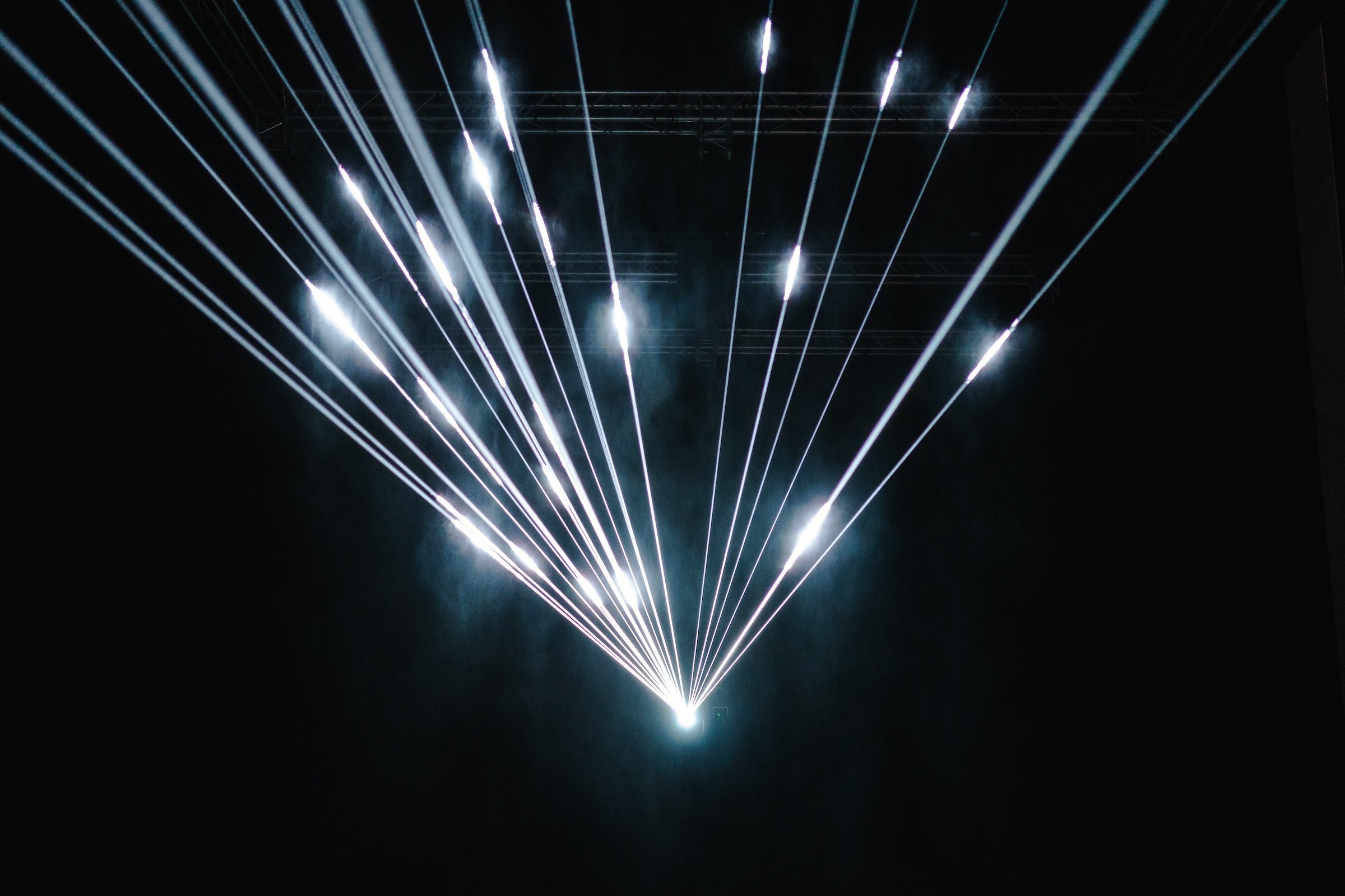 Studio Lemercier's "Lightfall," a laser light project on a screen of gently falling water droplets.