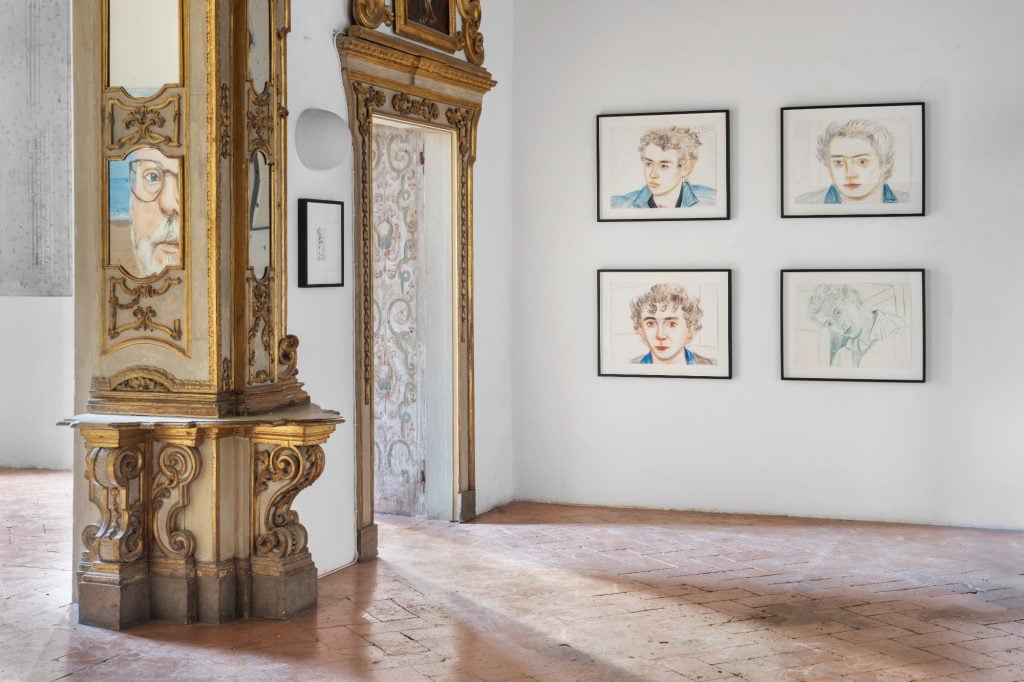 a very ornate interior with some colorful portraits hanging on the wall