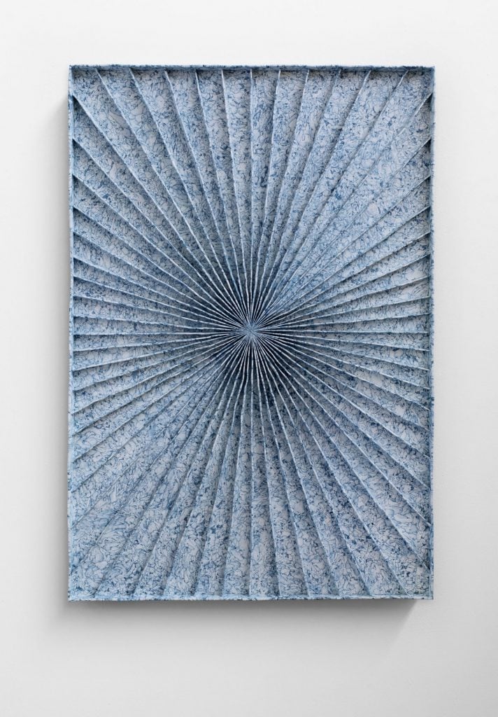 Levi van Veluw, Celestial Alignment (2024). A blue and white wall hanging sculptural work made from bands of polymer clay. 