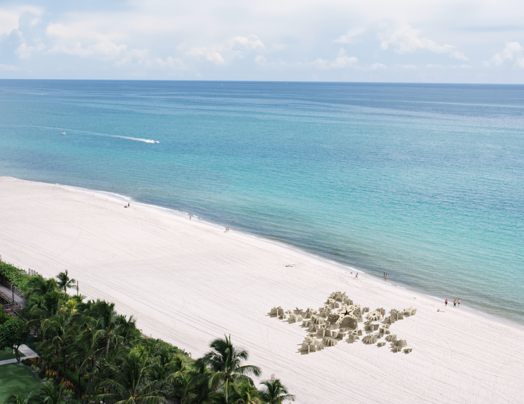 Carlos Betancourt and Alberto Latorre, <em>Miami Reef Star</em> (2024), rendering. A drone view of concrete star sculptures arrayed in a star pattern on the beach.