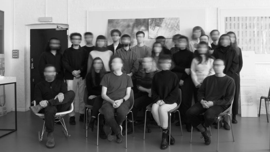 a black and white photo of a group of people with their faces slightly blurred