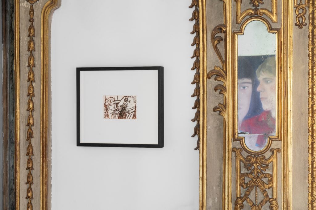 a close up of a very ornate interior with some colorful portraits hanging on the wall