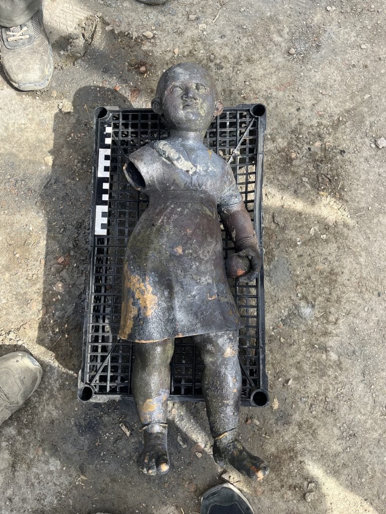 overhead shot of a child with ball made of metal found at the baths