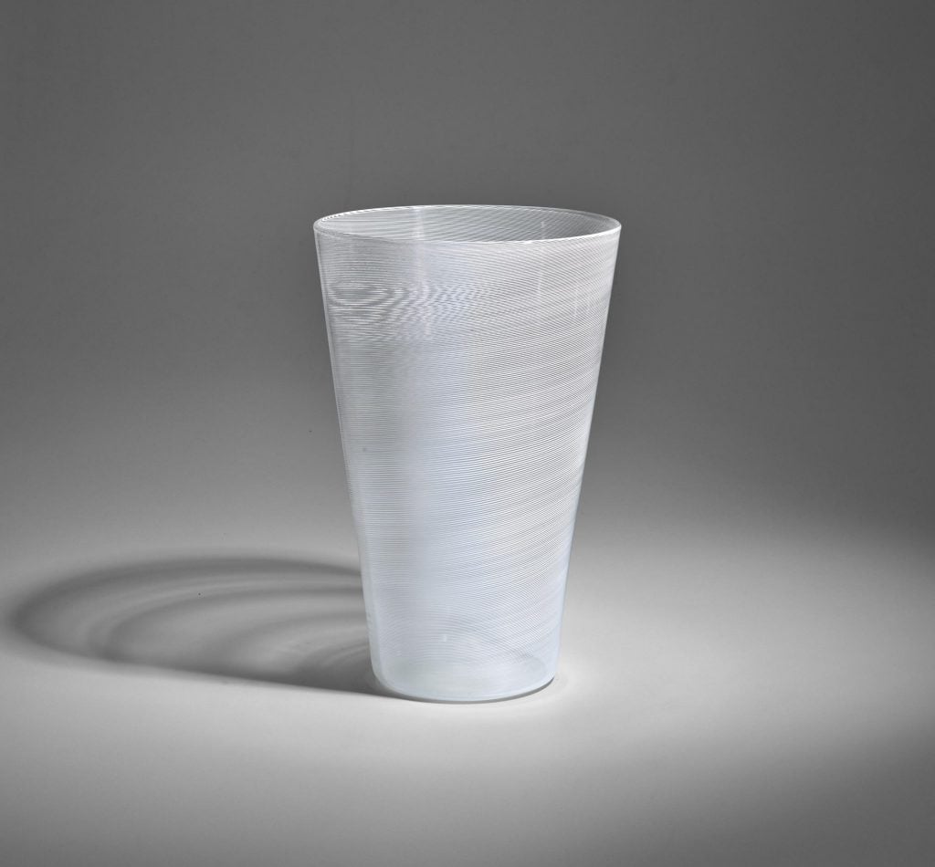 A white vase with a lightly latticed surface