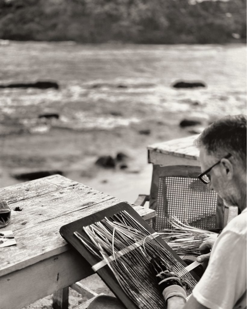 an image of Marcelo weaving a paper photograph