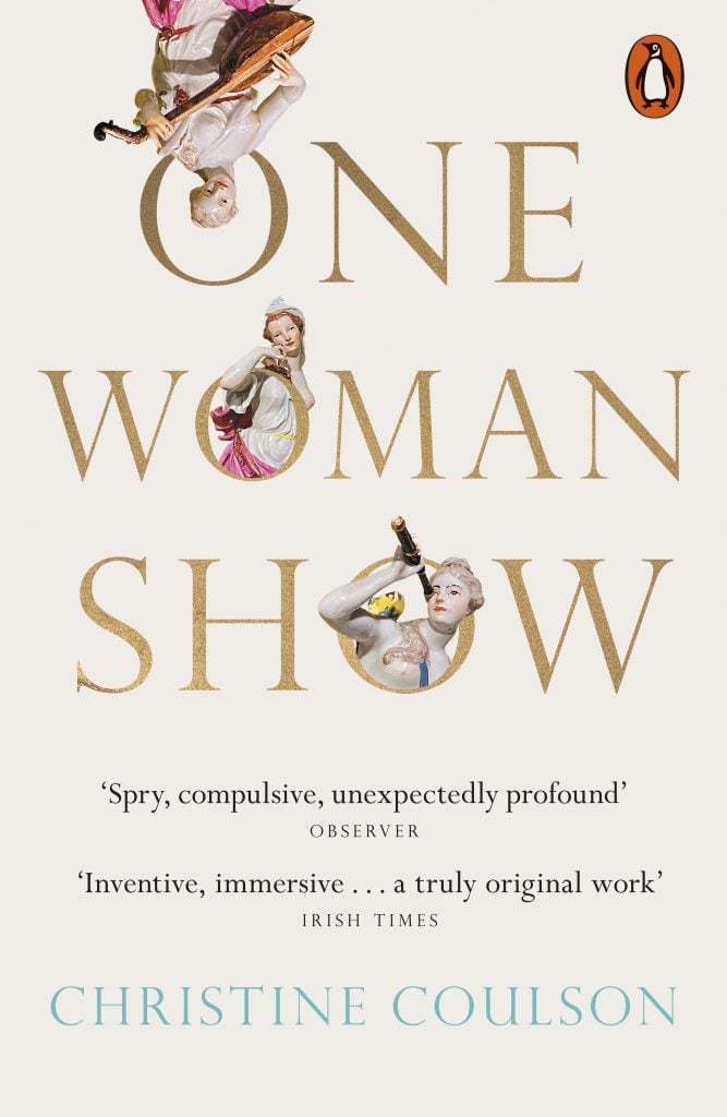 a white book cover with gold text reading 'one woman show'