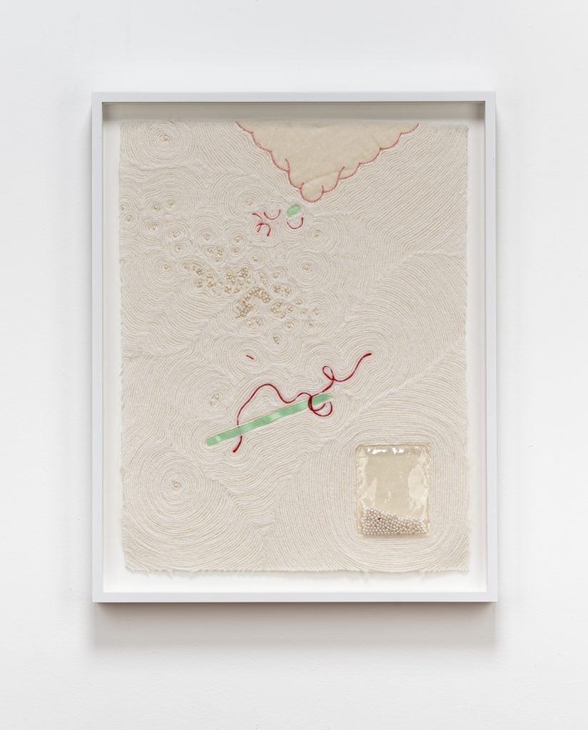 a white thread collage, arranged in delicate rivulets, with ribbons other small ribbons in between.