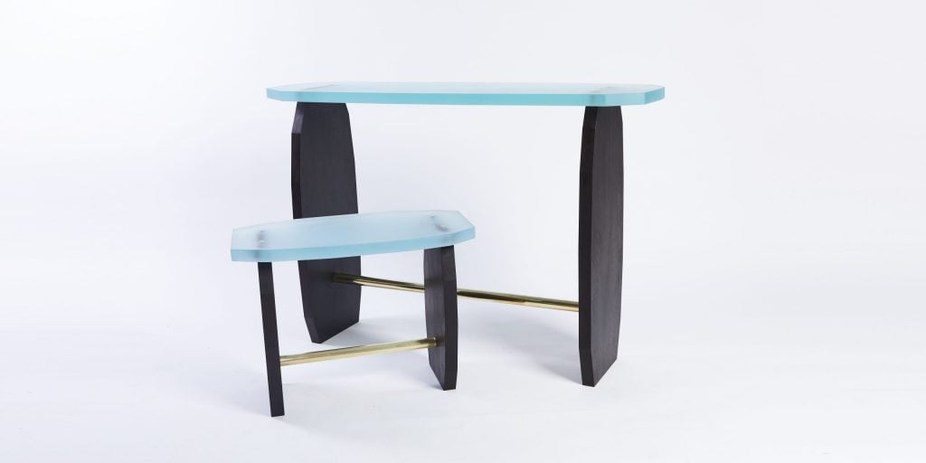 a stool and console have black legs and a blue top 