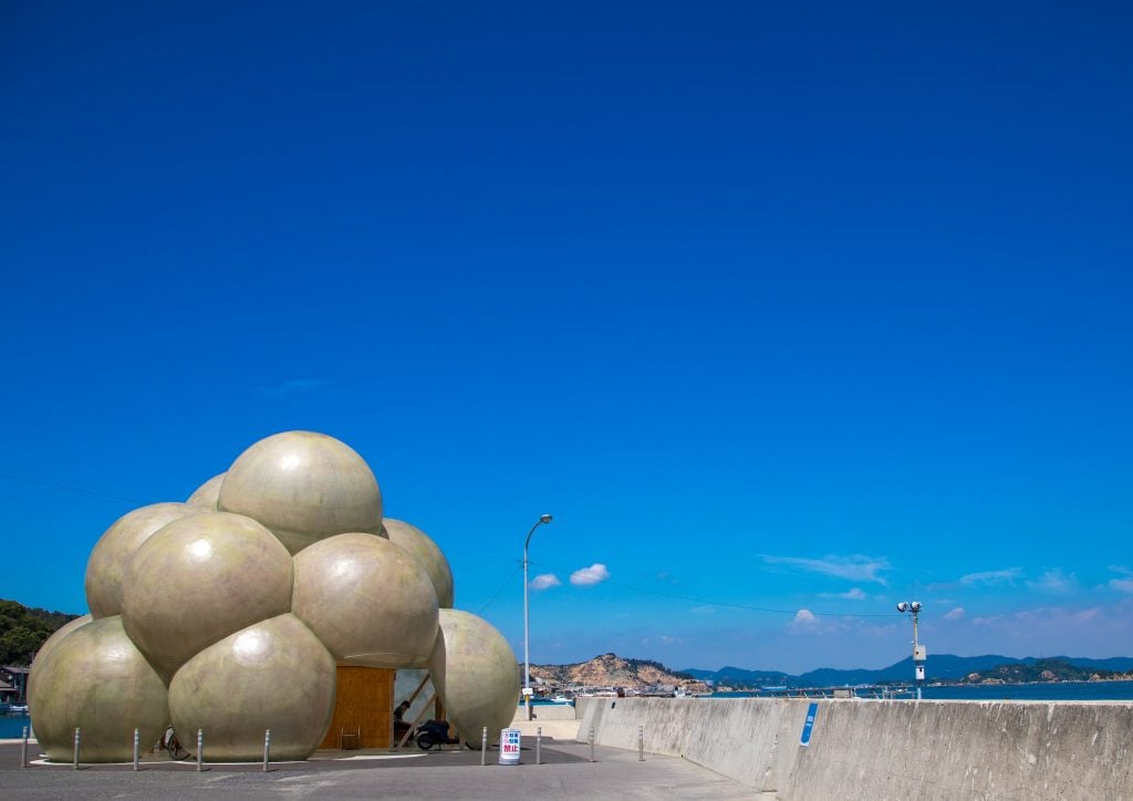 a terminal is shaped like a cloud next to the sea 