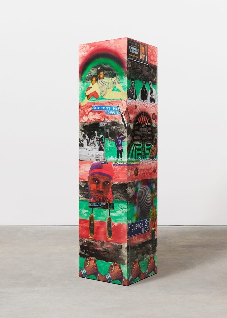 a sculptural column has images of modern black life 