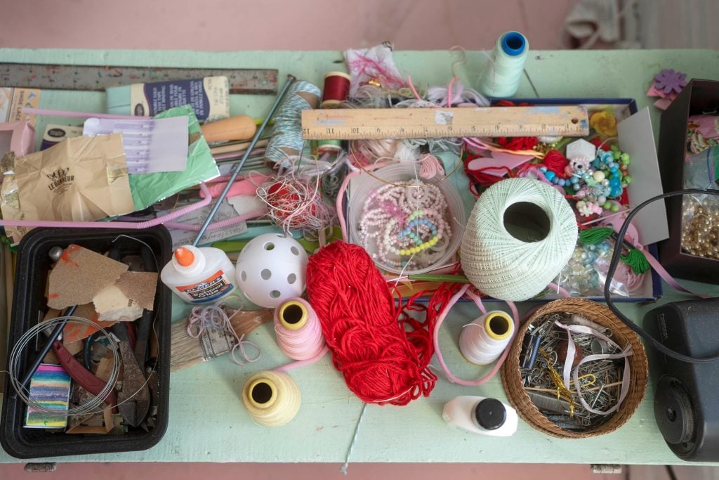 spools of thread, glue, and other objects on a table