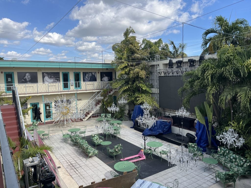 A color photo shows an event space at a moderately sized hotel dating from the mid 20th century