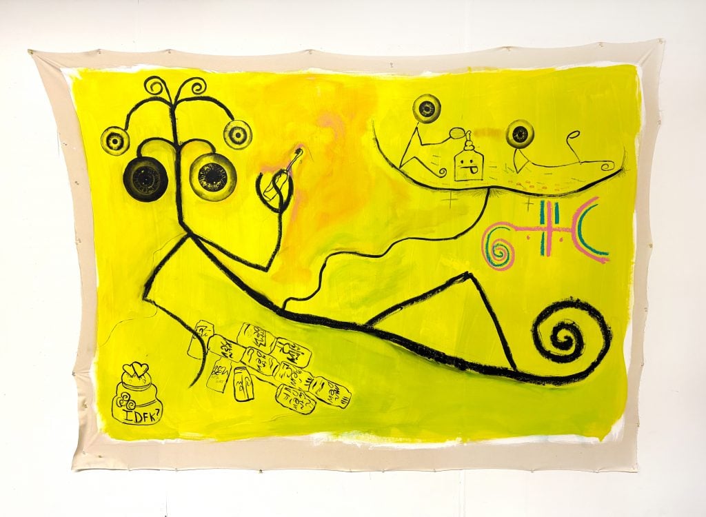 A vibrant abstract painting on a yellow background featuring black, whimsical line figures with circular eye-like shapes and curly designs. Additional elements include playful symbols, a jar labeled "IDFK?" with hearts, scattered rectangles resembling tiles, and colorful spiral and geometric motifs. The artwork has a raw, expressive style with unfinished edges.