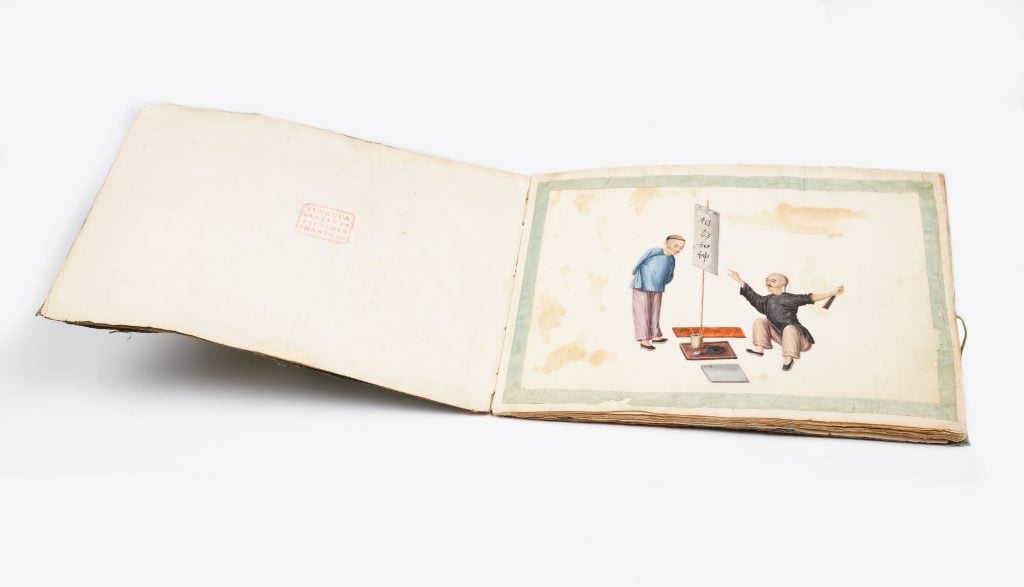 An open book shows a page of two Qing dynasty Chinese men getting their future predicted