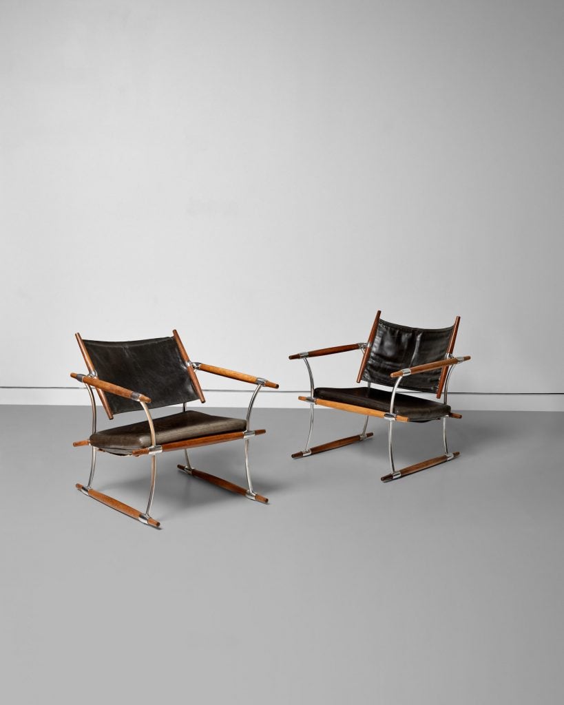 a pair of chairs made of wood and leather