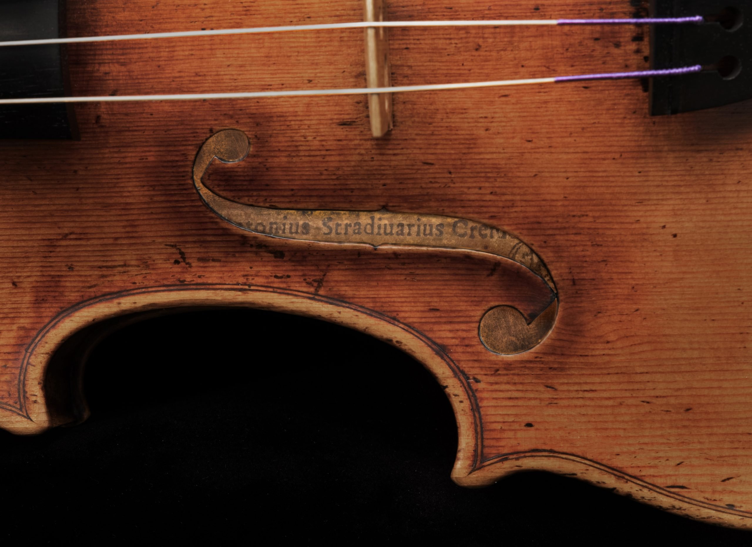 Close-up of a Stradivarius violin showing weathered wood grain