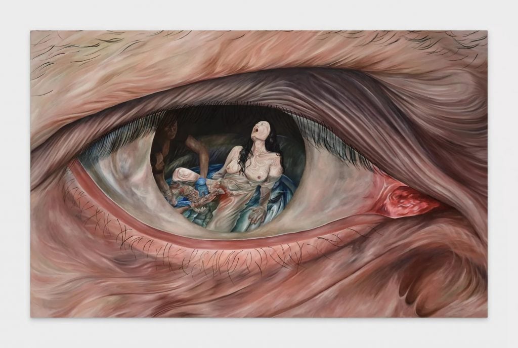 a massive painting of an eye and in the iris is a scene of a woman giving birth