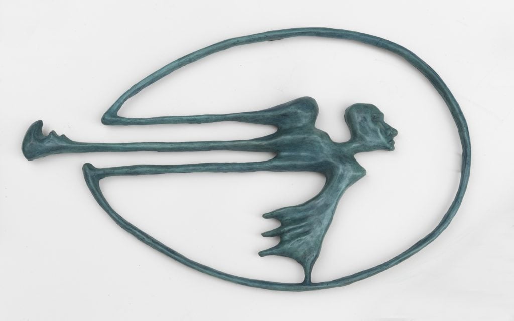 A Helen Evans Ramsaran bronze sculpture that looks like a flying figures inside a thin oval. 