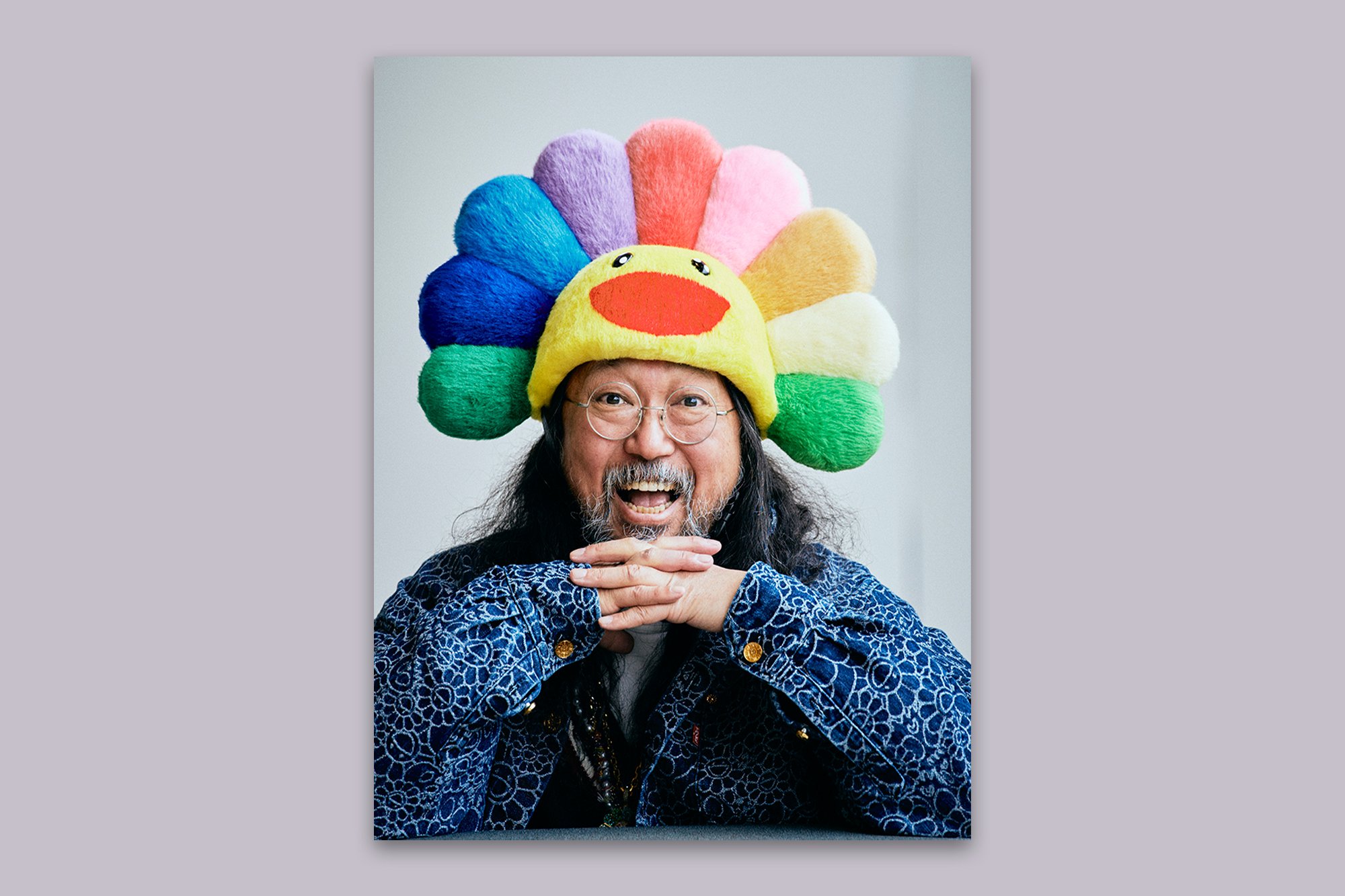 Takashi Murakami wearing a rainbow flower headdress